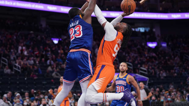 Dec 3, 2021; San Francisco, California, USA; Phoenix Suns forward Jae Crowder (99) is fouled by Golden State Warriors forward Draymond Green (23) in the third quarter at the Chase Center. Mandatory Credit: Cary Edmondson-USA TODAY Sports